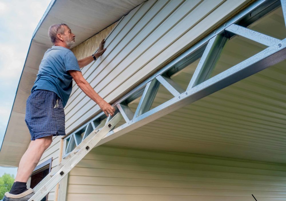 Home Remodeling Minneapolis - A Man Installing Siding