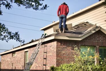 Man standing on a roof.