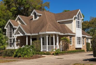 A white house with a brown roof.