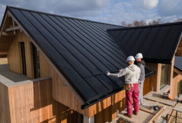 two workers taking care of roofing and curb appeal of a house