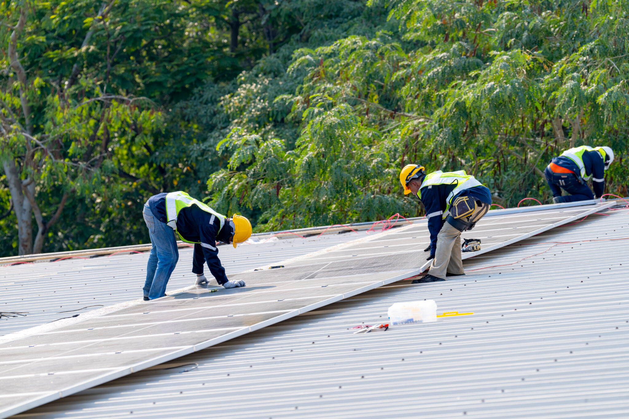 Areas We Serve - Two Roofers Working On a Commercial Roof Replacement Project in St Paul