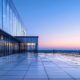 Why TPO Roofing Is Ideal for Your Commercial Building 7 a sleek, modern commercial building showcases a robust tpo roofing system, featuring a bright, reflective surface that contrasts with the urban skyline, illuminated under sharp studio lighting to emphasize durability and innovation.