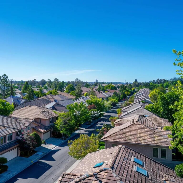 Sturdy roof in a suburban neighborhood highlighting seasonal maintenance importance