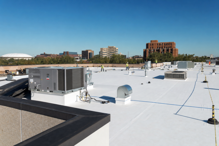 Commercial flat TPO roof on a Falcon Heights, MN business with HVAC units and Twin Cities skyline