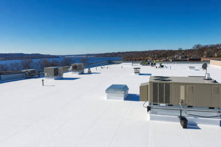 Commercial flat TPO roof on a Hastings, MN business with HVAC units and Twin Cities skyline