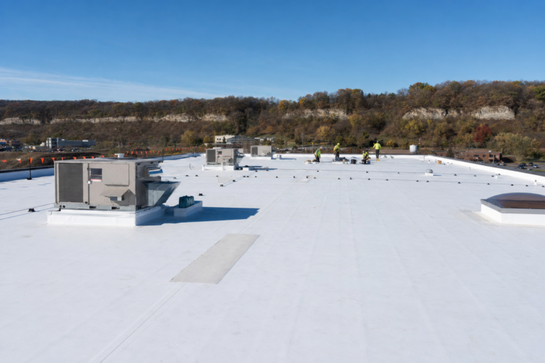 Commercial flat TPO roof on a Mendota Heights, MN business with HVAC units and Twin Cities skyline