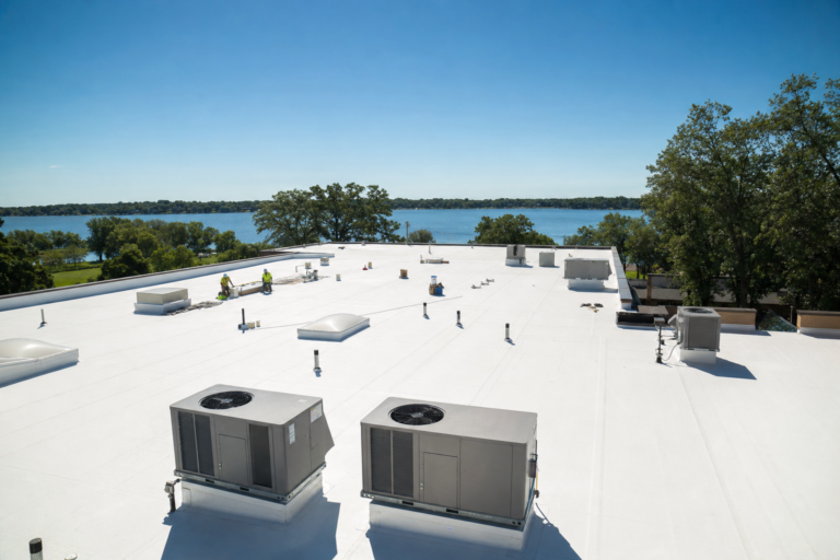 Commercial flat TPO roof on a White Bear Lake, MN business with HVAC units and Twin Cities skyline