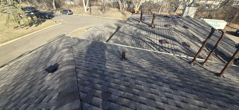 Newly completed residential shingle roof with multiple roof planes, plumbing vent stacks and box vents — Sellers Roofing project in the Twin Cities, MN