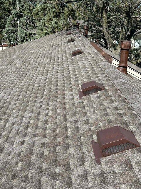 Completed residential architectural shingle roof with multiple bronze box vents and turbine attic vent — Sellers Roofing project in the Twin Cities, MN
