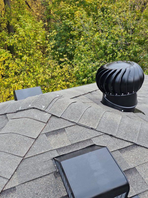 Black turbine attic vent and box vent installation on a newly completed residential shingle roof in Saint Paul, MN by Sellers Roofing