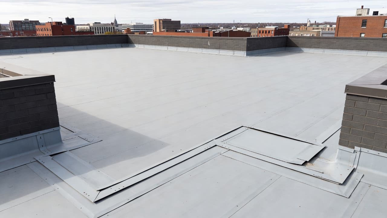 What Is a Reservation of Rights Letter for a Roof Claim? A commercial flat roof membrane and flashing details during an inspection.