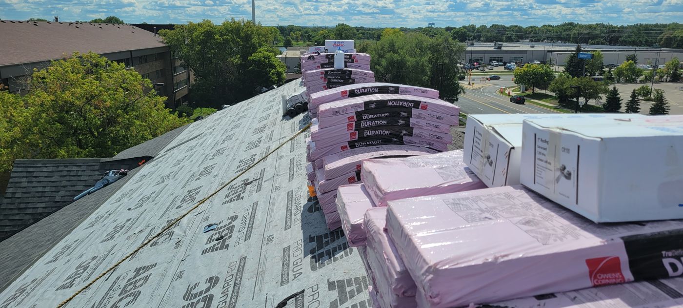 Commercial & Residential Roofing in Saint Paul, MN | Sellers Roofing Owens Corning Duration shingle bundles staged on the ridge during a Sellers Roofing roof replacement in the Twin Cities
