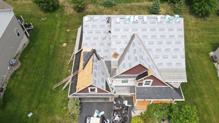 Drone view of residential roof tear-off and synthetic underlayment installation by Sellers Roofing in Eden Prairie, MN