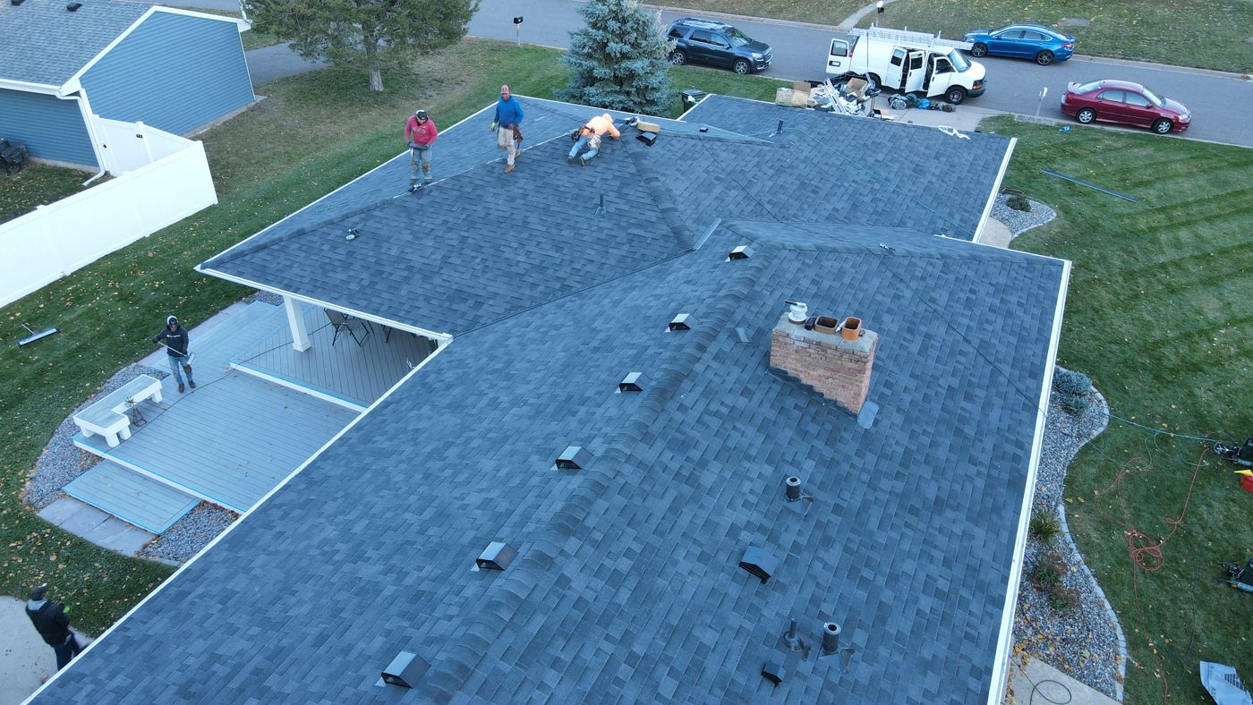 Commercial & Residential Roofing in Saint Paul, MN | Sellers Roofing Sellers Roofing crew finishing an architectural shingle roof replacement in St. Anthony, MN