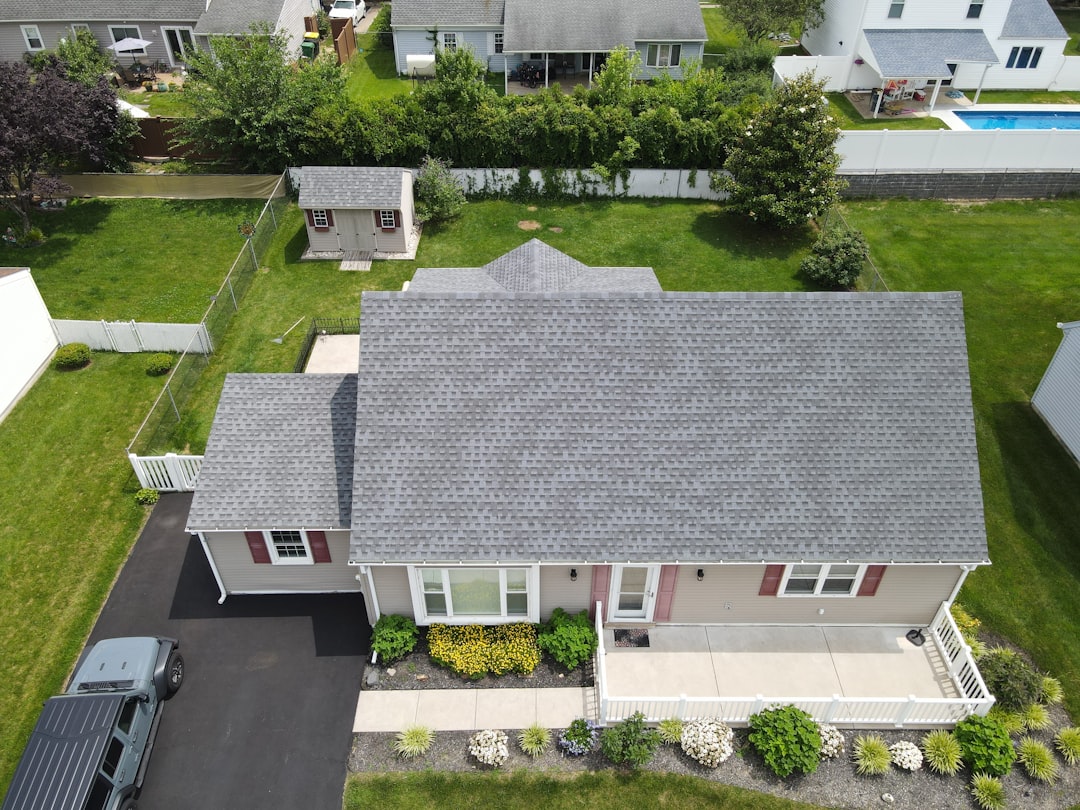Minnesota Roof Storm Damage & Insurance Claims Guide Asphalt shingle roof on a suburban home being evaluated after storm damage