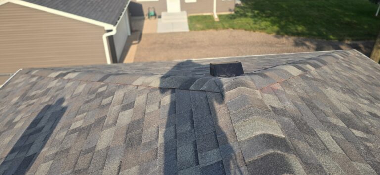 Hip-roof and vent details Asphalt-shingle hip roof with capped ridges, a box vent, and a work line across the roof.